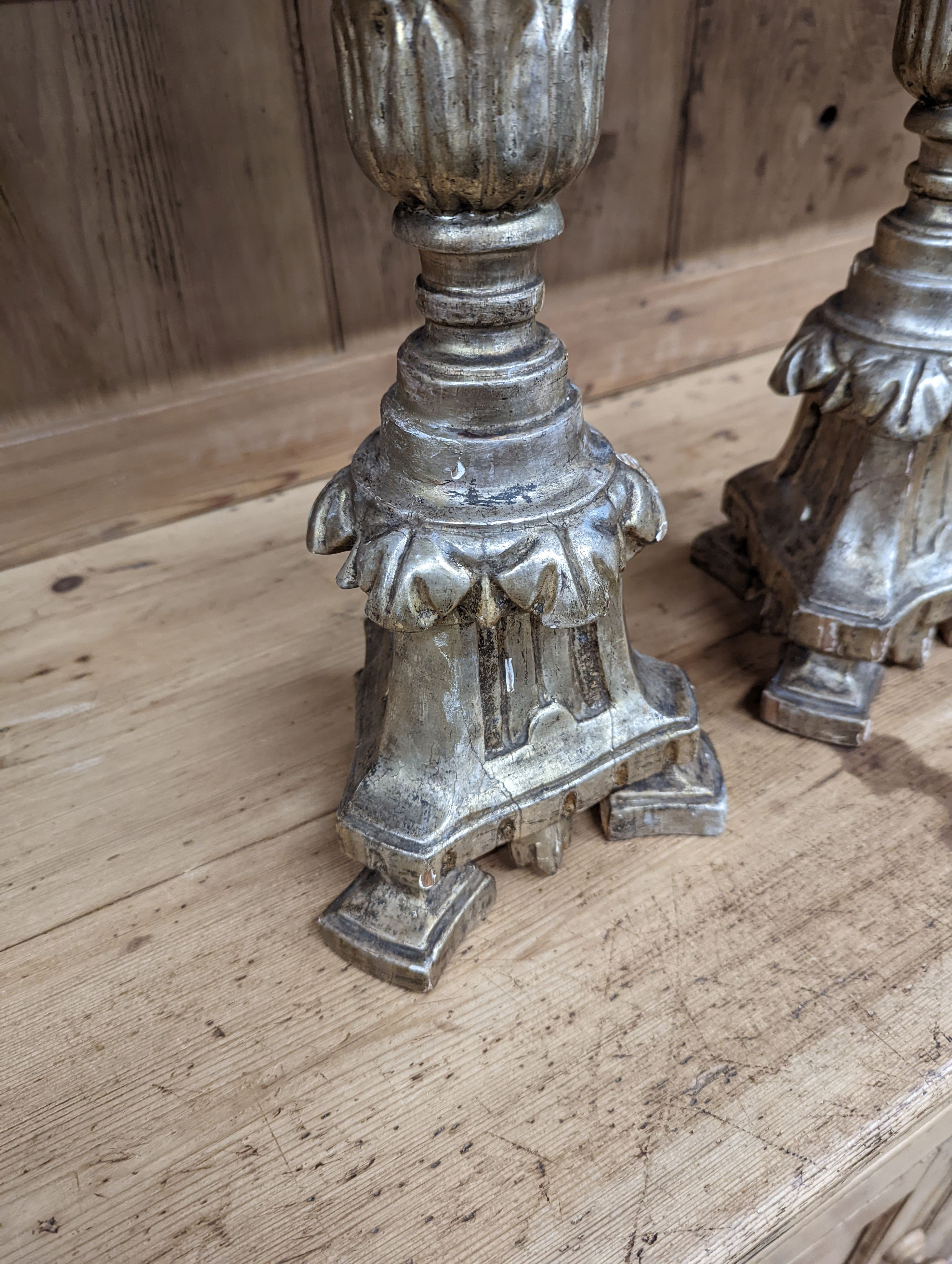 A pair of 18th century style carved silvered wood candlesticks, height 58cm